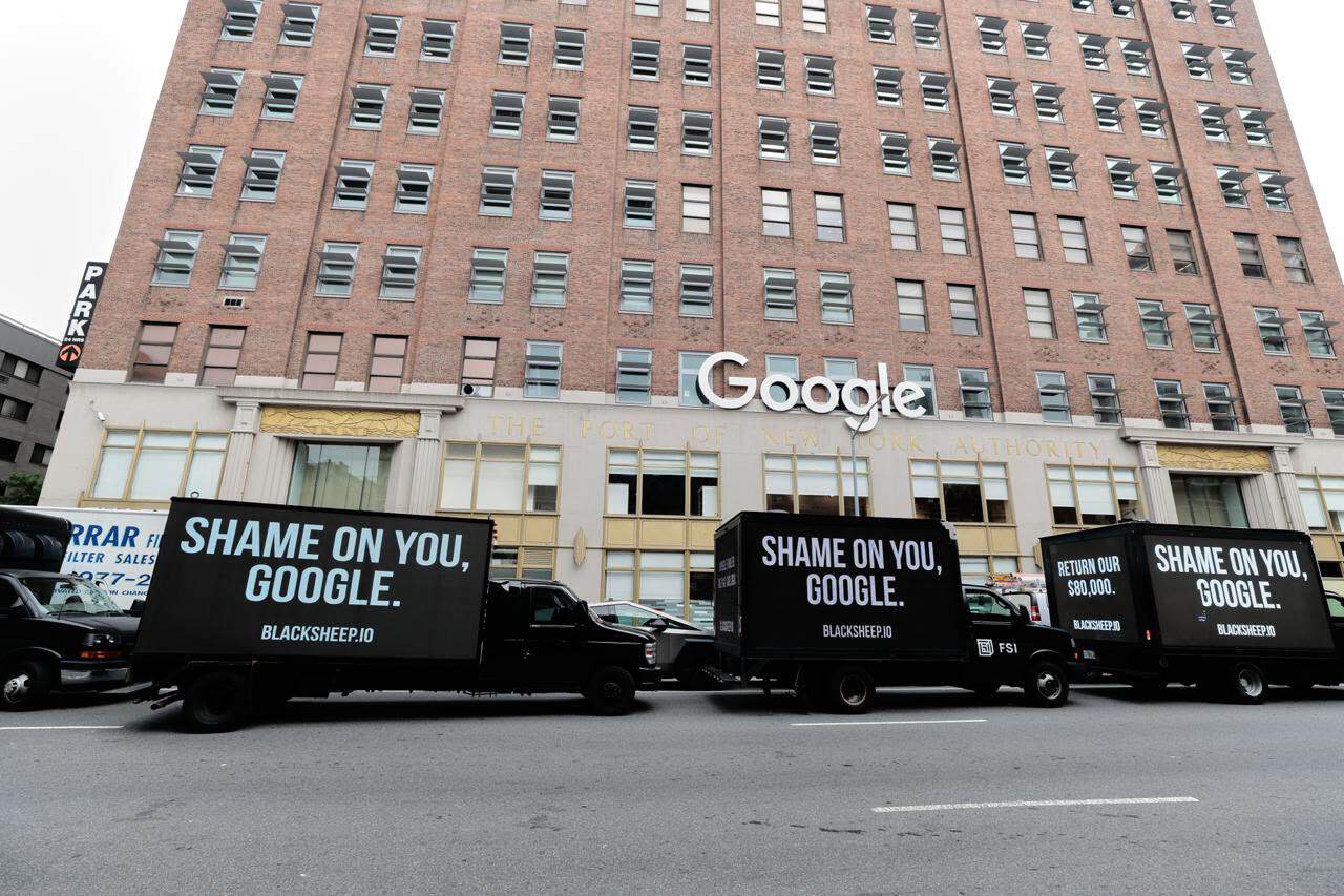 LED truck displaying 'SHAME ON YOU GOOGLE' in front of Google Chelsea campus