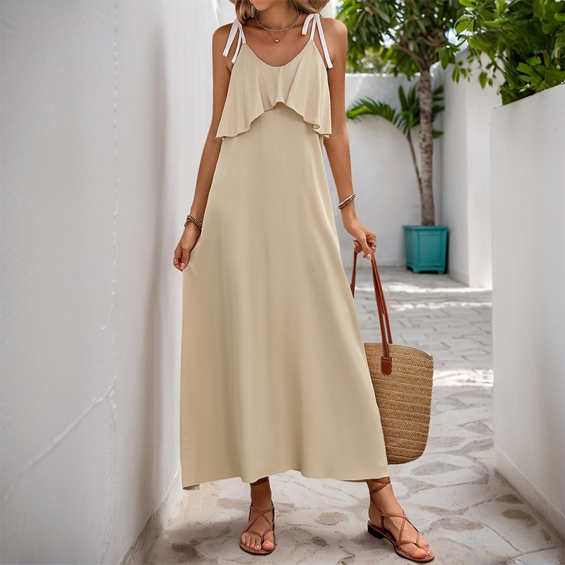 Abito lungo svolazzante beige da donna con volant e laccetti sulle spalle.