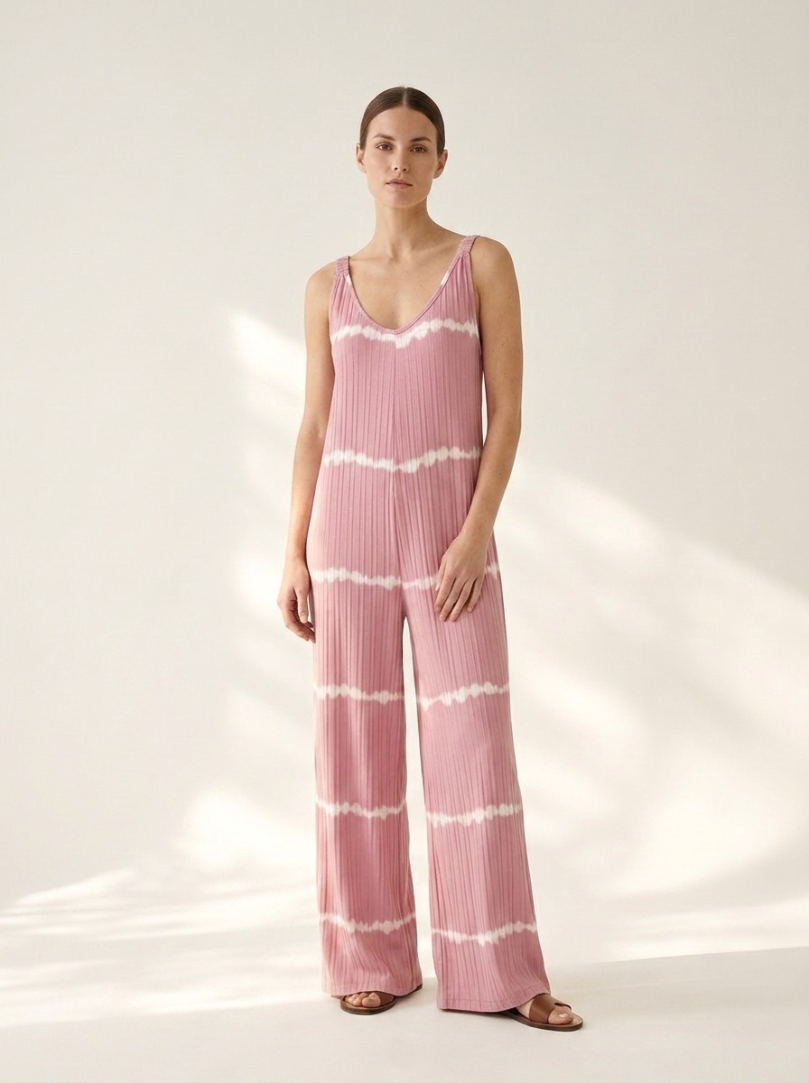 Tuta intera rosa a coste con scollo a V e gamba larga, stampa tie-dye.
