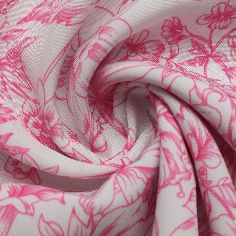 Chemisier rose à fleurs, manches à volants et nœud dans le dos