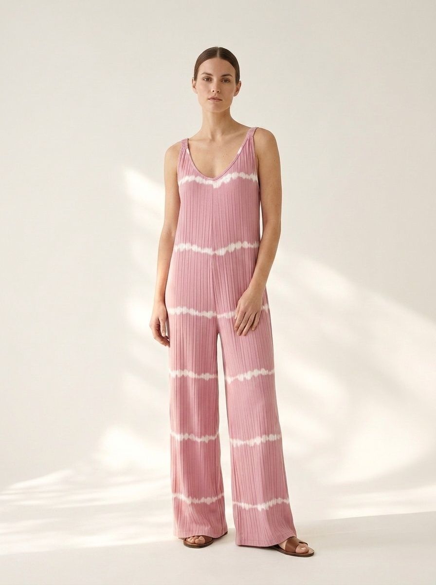 Tuta intera rosa a coste con scollo a V e gamba larga, stampa tie-dye.