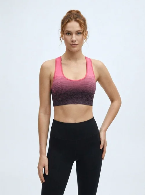 Reggiseno sportivo snellente da donna con spalline incrociate sulla schiena, ammortizzante e traspirante, con design sfumato.