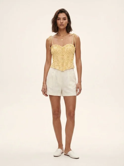 Elegante top a corsetto con volant e spalline da annodare.