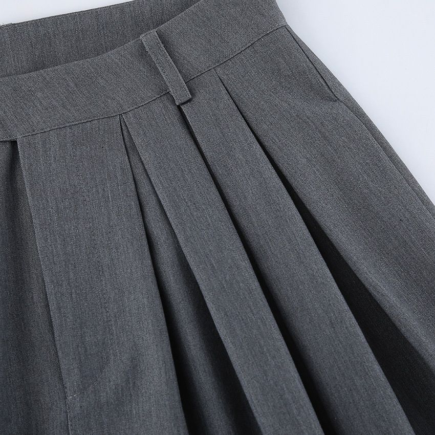 Pantalones grises de mujer de talle alto y pierna ancha con pliegues.