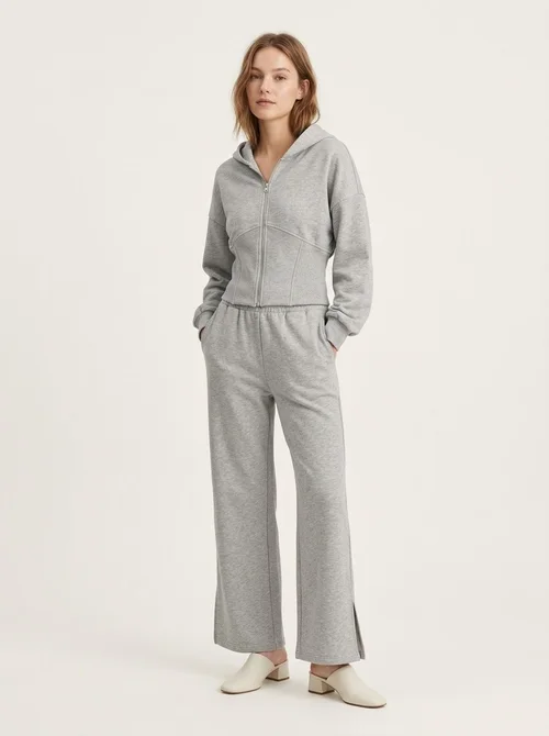 Completo composto da felpa con cappuccio a corsetto e pantaloni a gamba larga color grigio melange