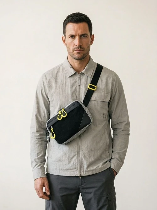 Sleek Black Crossbody Bag with Bright Yellow Zippers