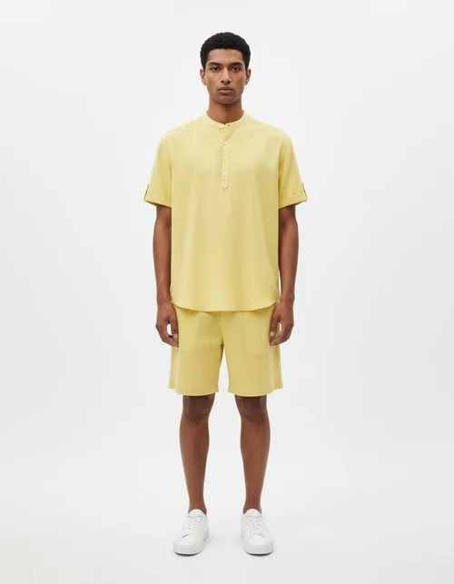 Completo da uomo estivo a tinta unita con camicia a maniche corte e colletto alto, maniche corte e pantaloncini.