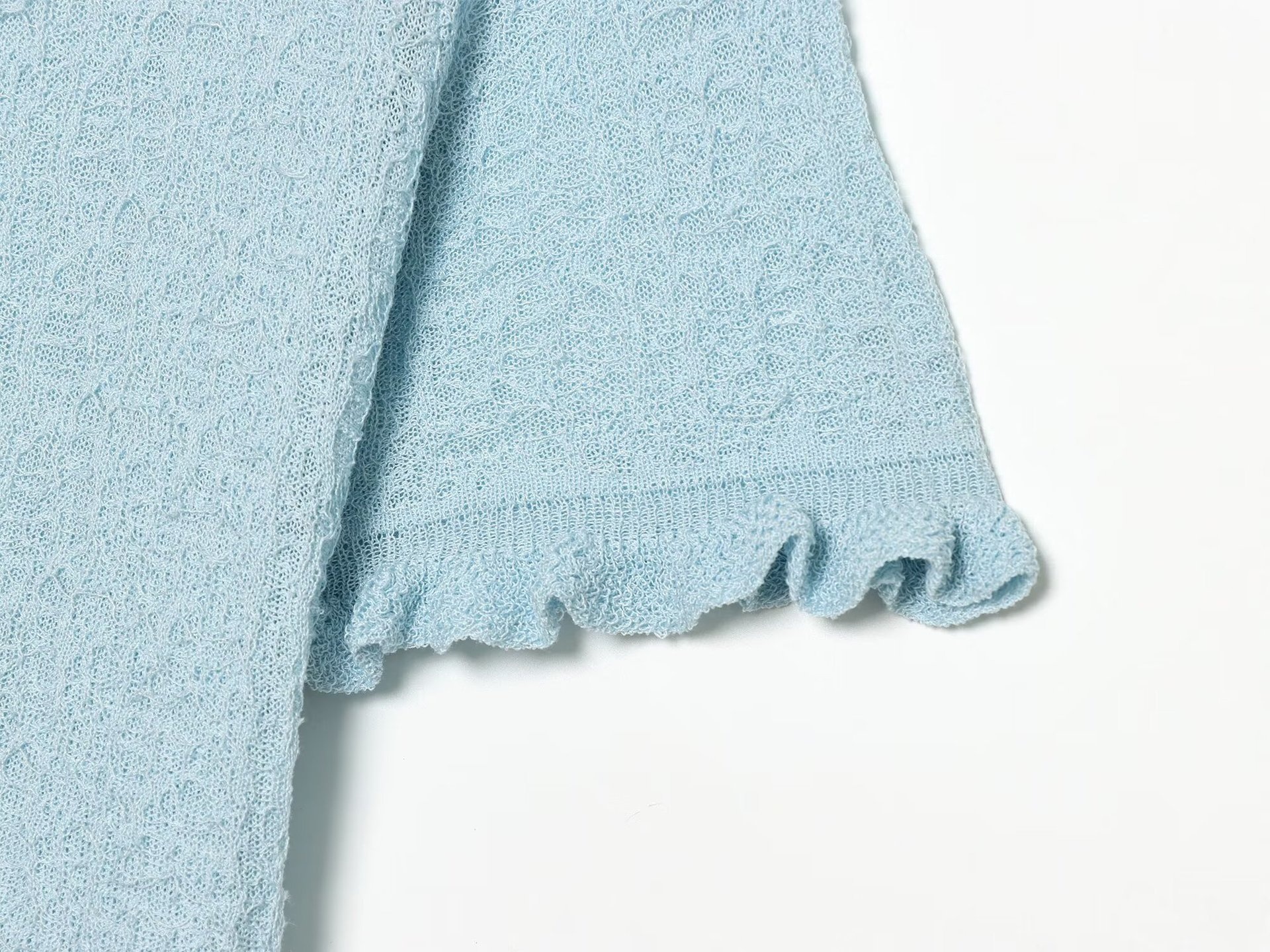 Cardigan chic a maniche corte con texture e volant.