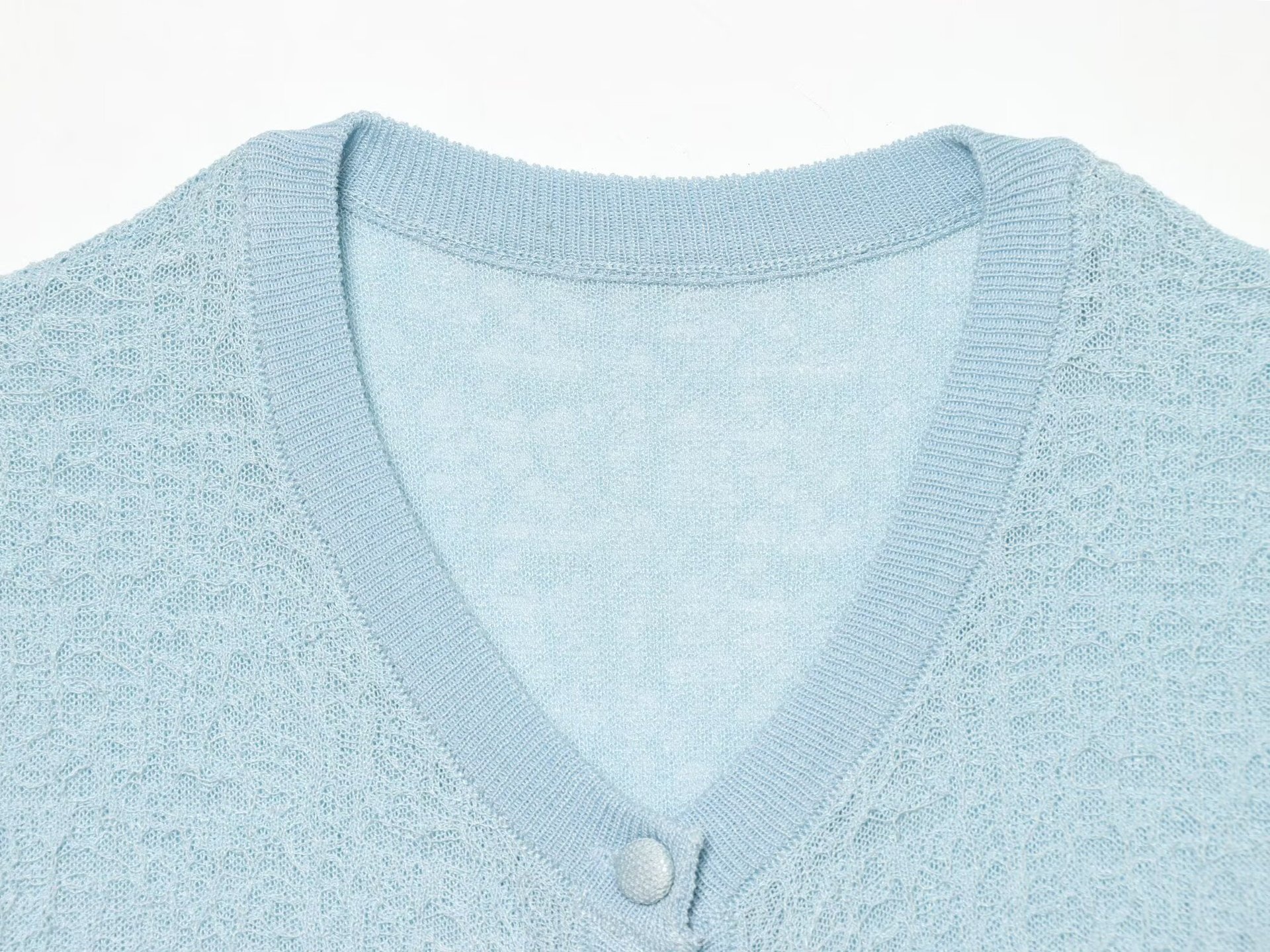 Cardigan chic a maniche corte con texture e volant.