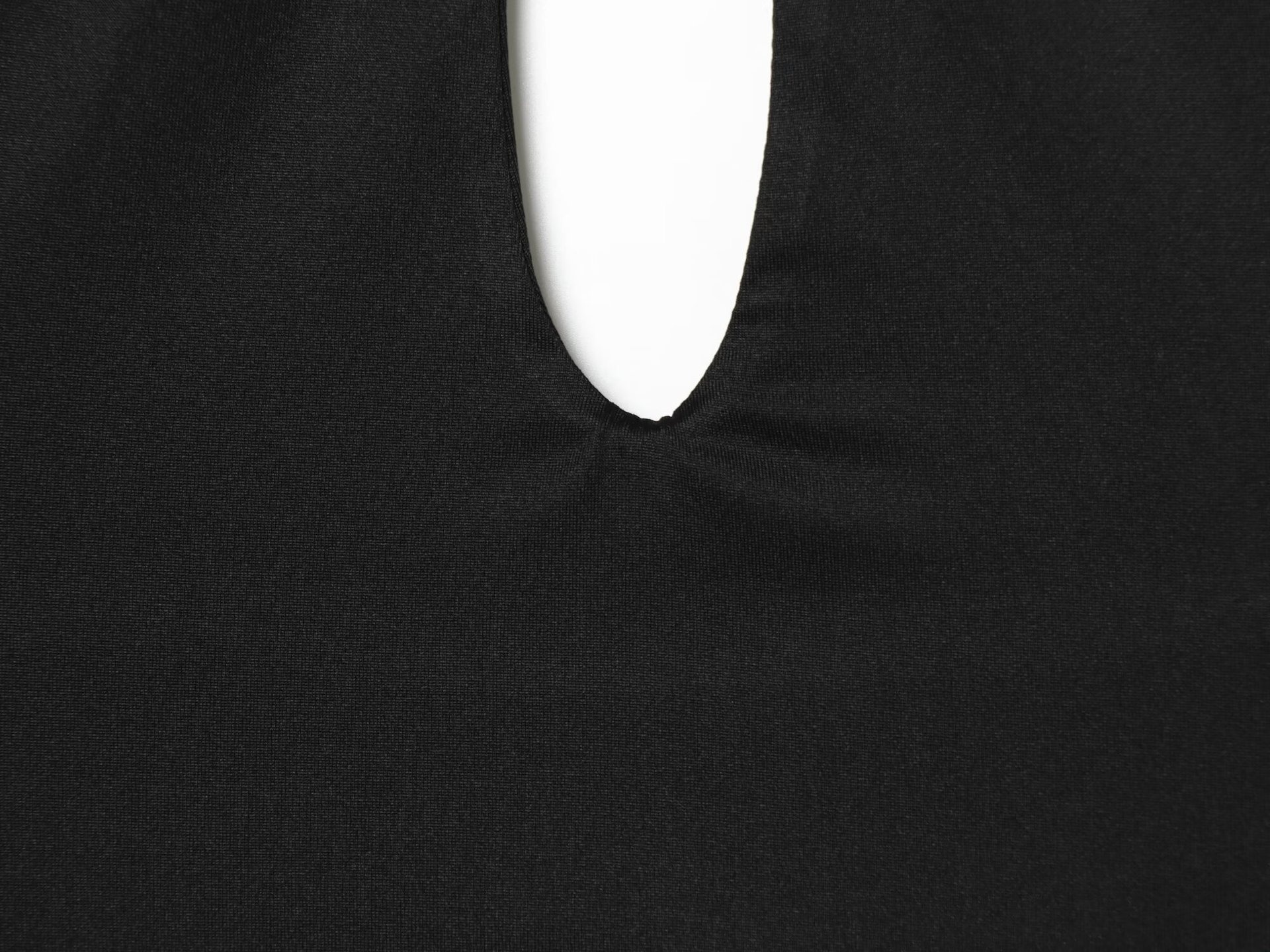 Elegante crop top nero con scollo all'americana e dettaglio ad anello dorato.