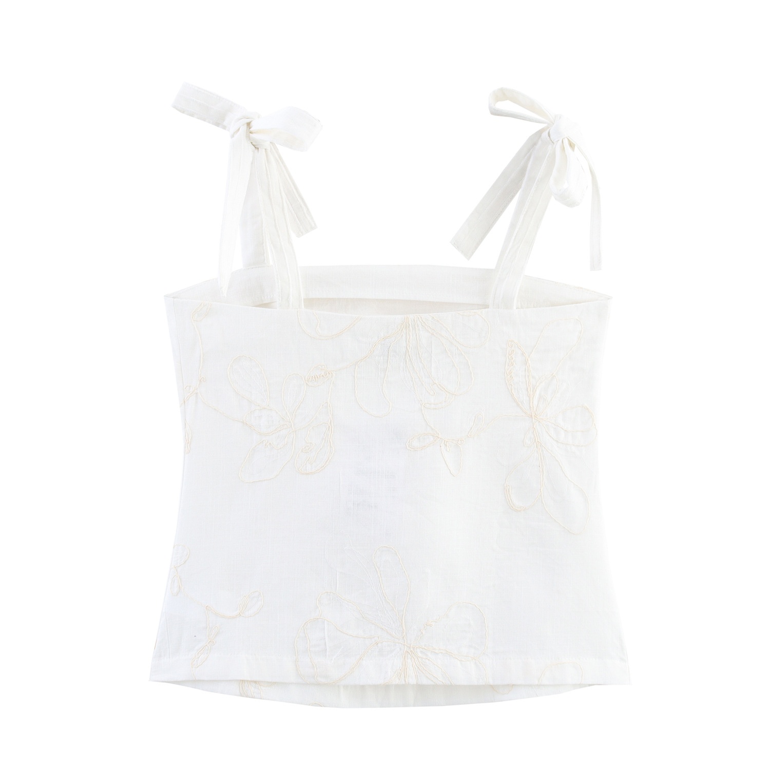 Top a canotta bianco con stampa floreale e laccetti sulle spalle.