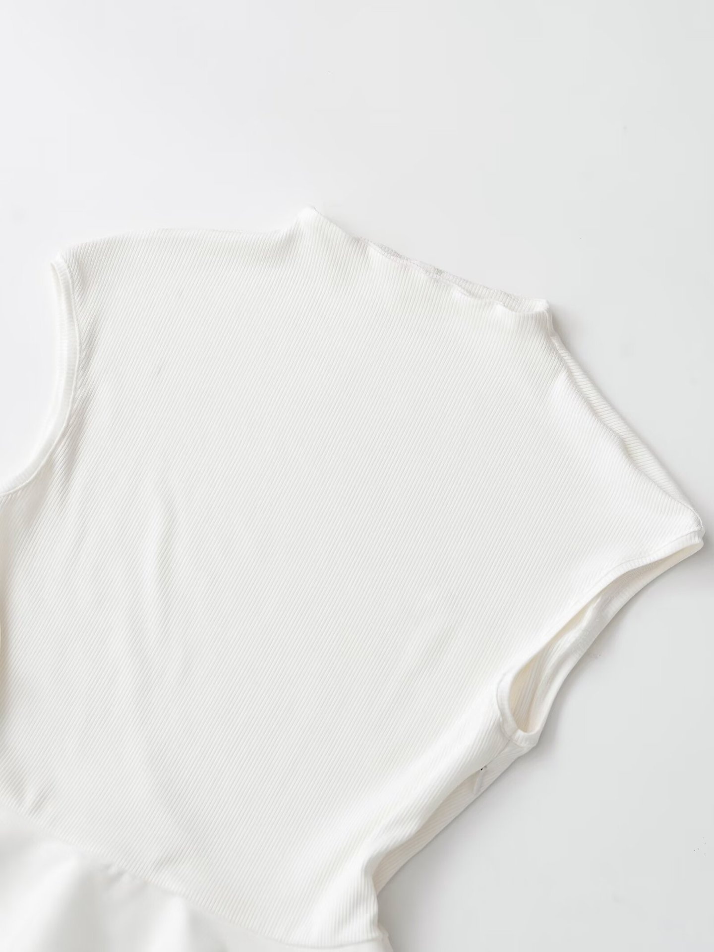Elegante top bianco a coste con baschina - Chic senza maniche con collo alto