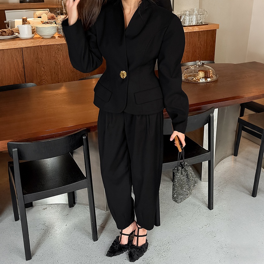 Completo da donna nero con blazer e pantaloni a sbuffo.
