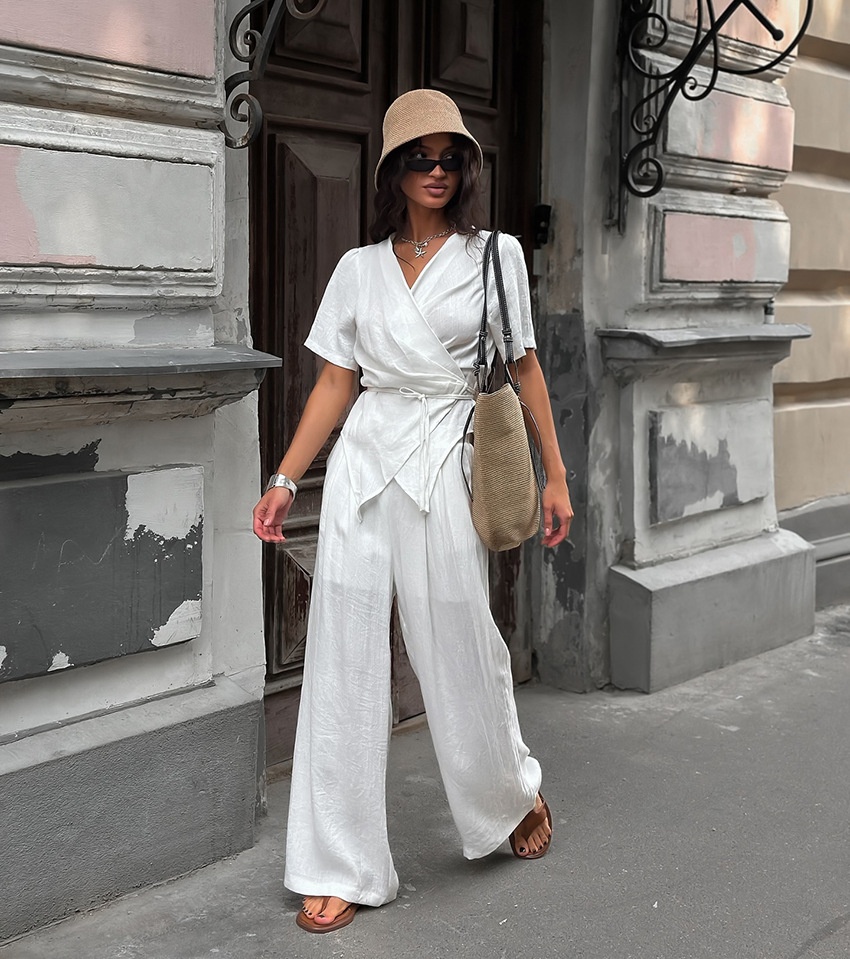 Completo da donna composto da top a portafoglio bianco e pantaloni a gamba larga.