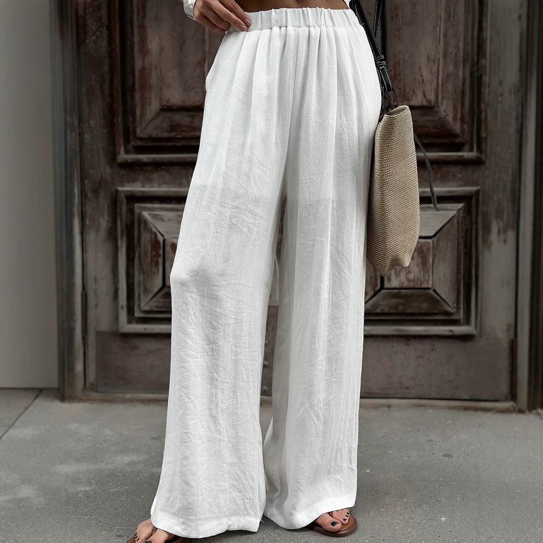 Completo da donna composto da top a portafoglio bianco e pantaloni a gamba larga.