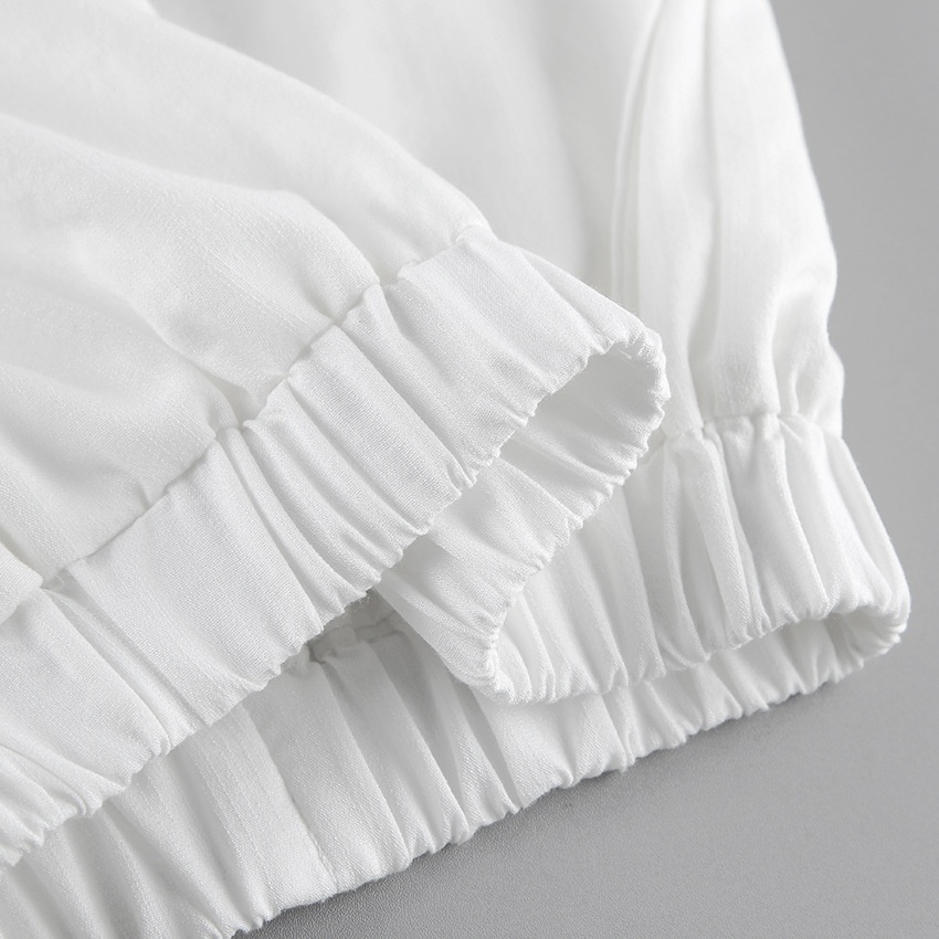 Completo da donna composto da top a portafoglio bianco e pantaloni a gamba larga.