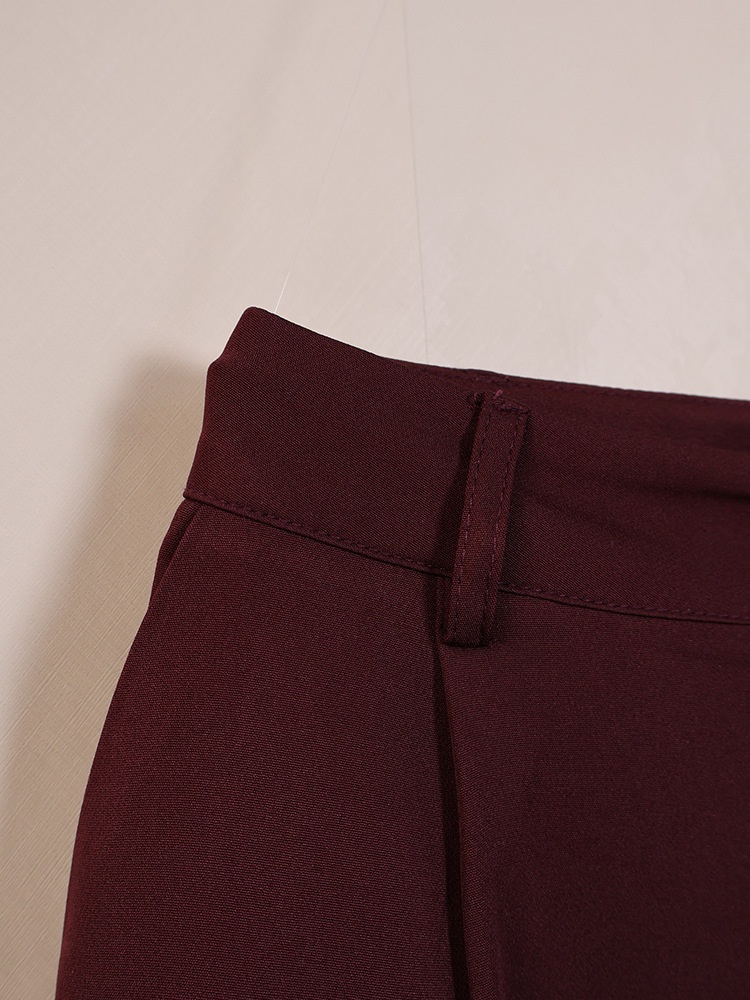 Completo da donna composto da blazer aderente e pantaloni a gamba larga color marrone scuro.