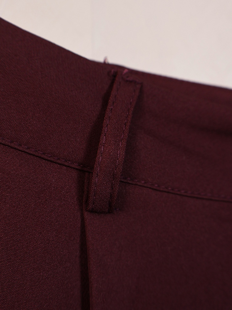 Completo da donna composto da blazer aderente e pantaloni a gamba larga color marrone scuro.