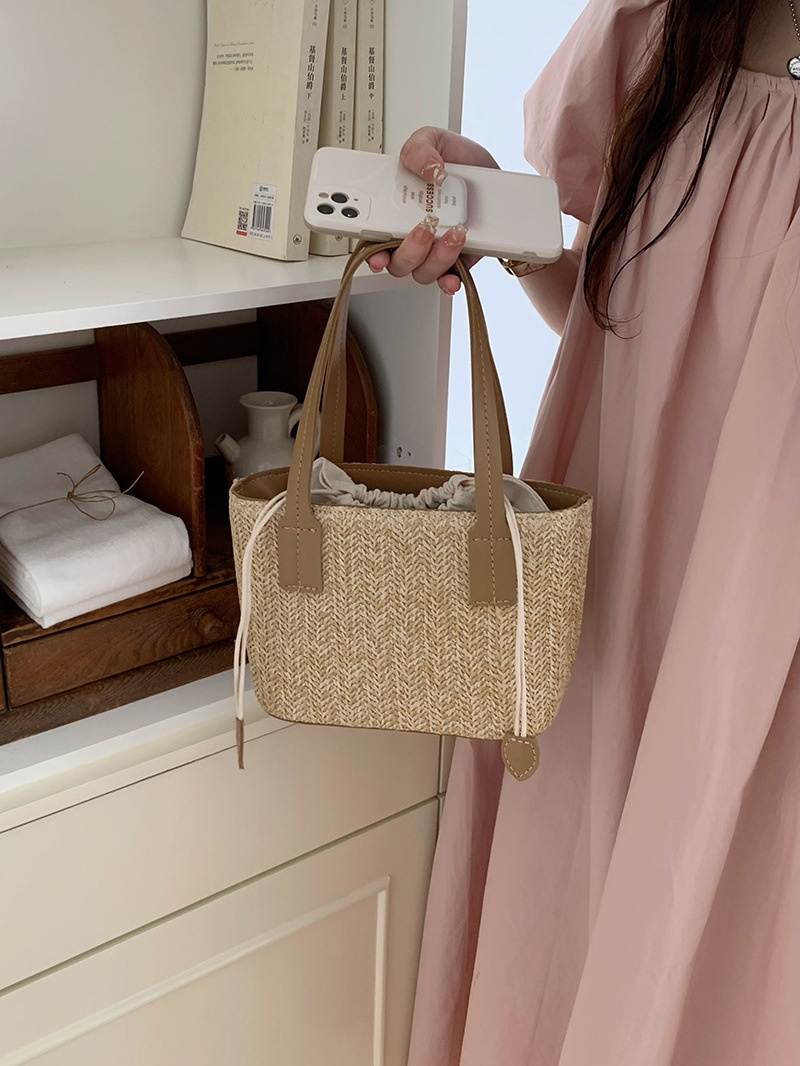 Minibolso elegante de paja tejida con forro de cordón ajustable.