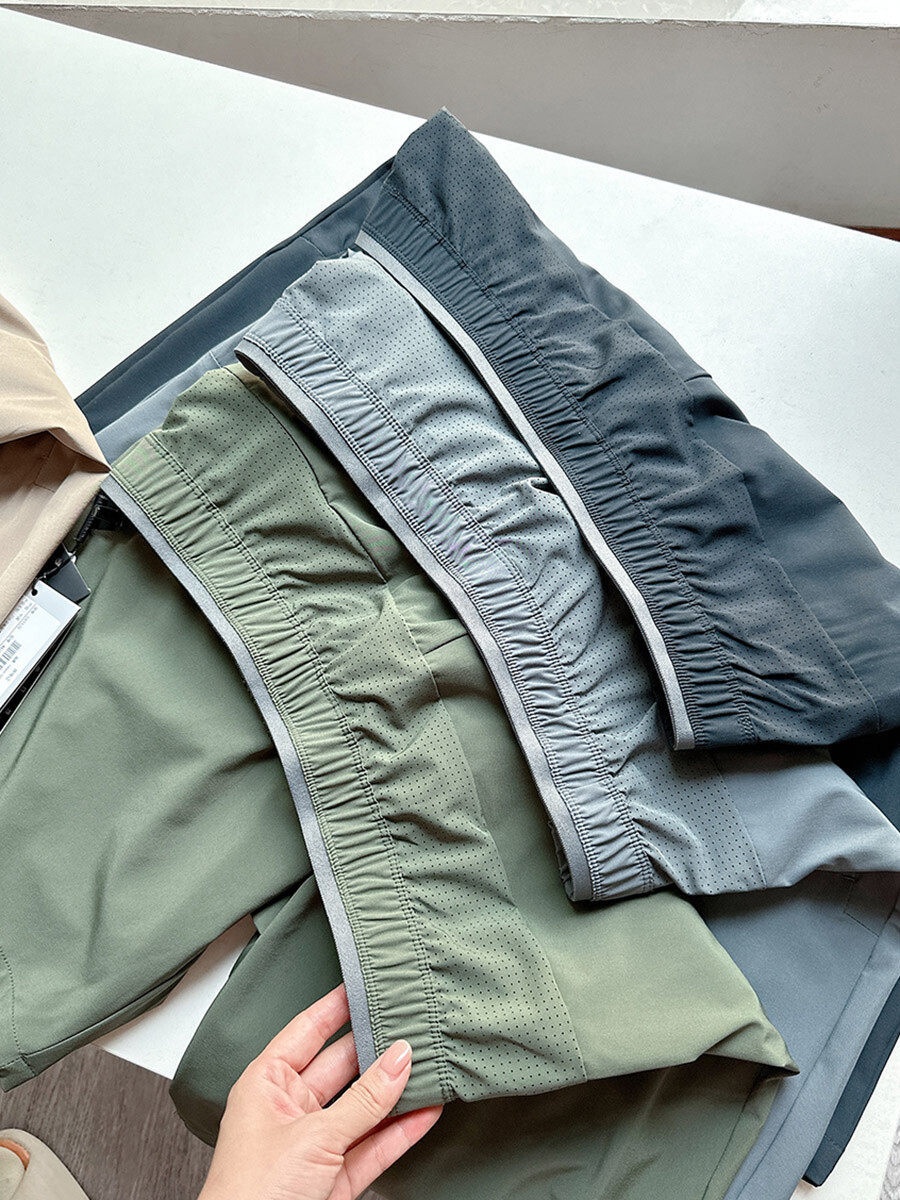 Pantaloncini sportivi da uomo in tessuto Teflon ad asciugatura rapida con tasche con cerniera.