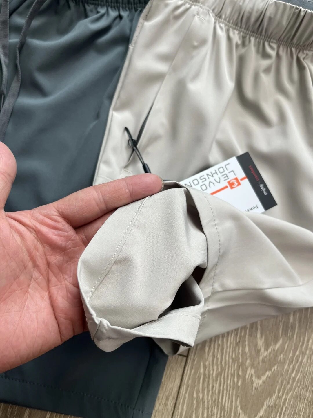 Pantaloncini sportivi da uomo in tessuto Teflon ad asciugatura rapida con tasche con cerniera.