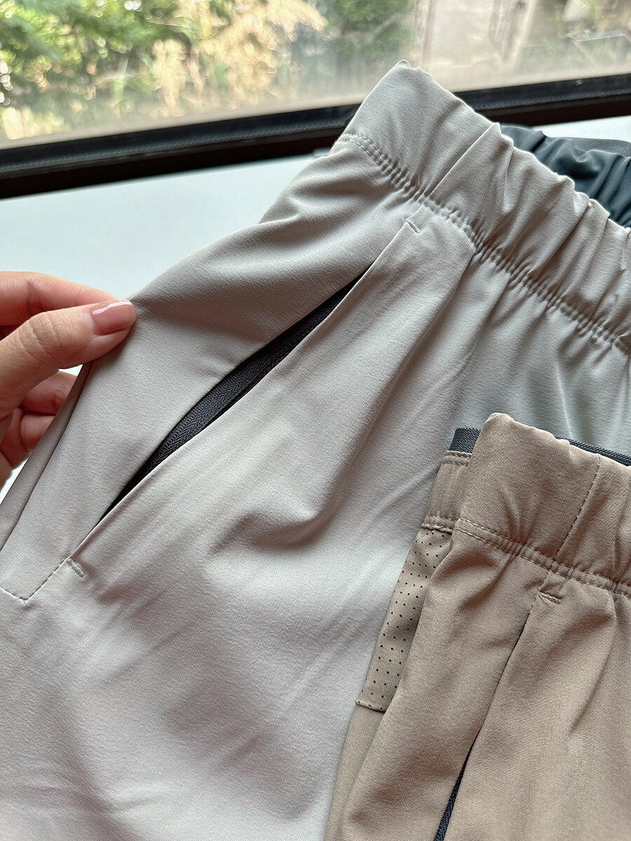 Pantaloncini sportivi da uomo in tessuto Teflon ad asciugatura rapida con tasche con cerniera.
