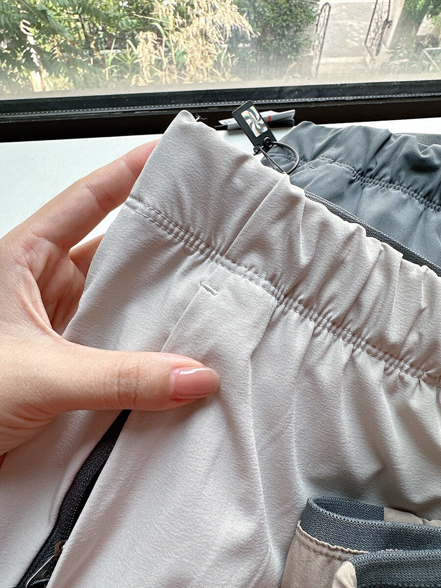 Pantaloncini sportivi da uomo in tessuto Teflon ad asciugatura rapida con tasche con cerniera.