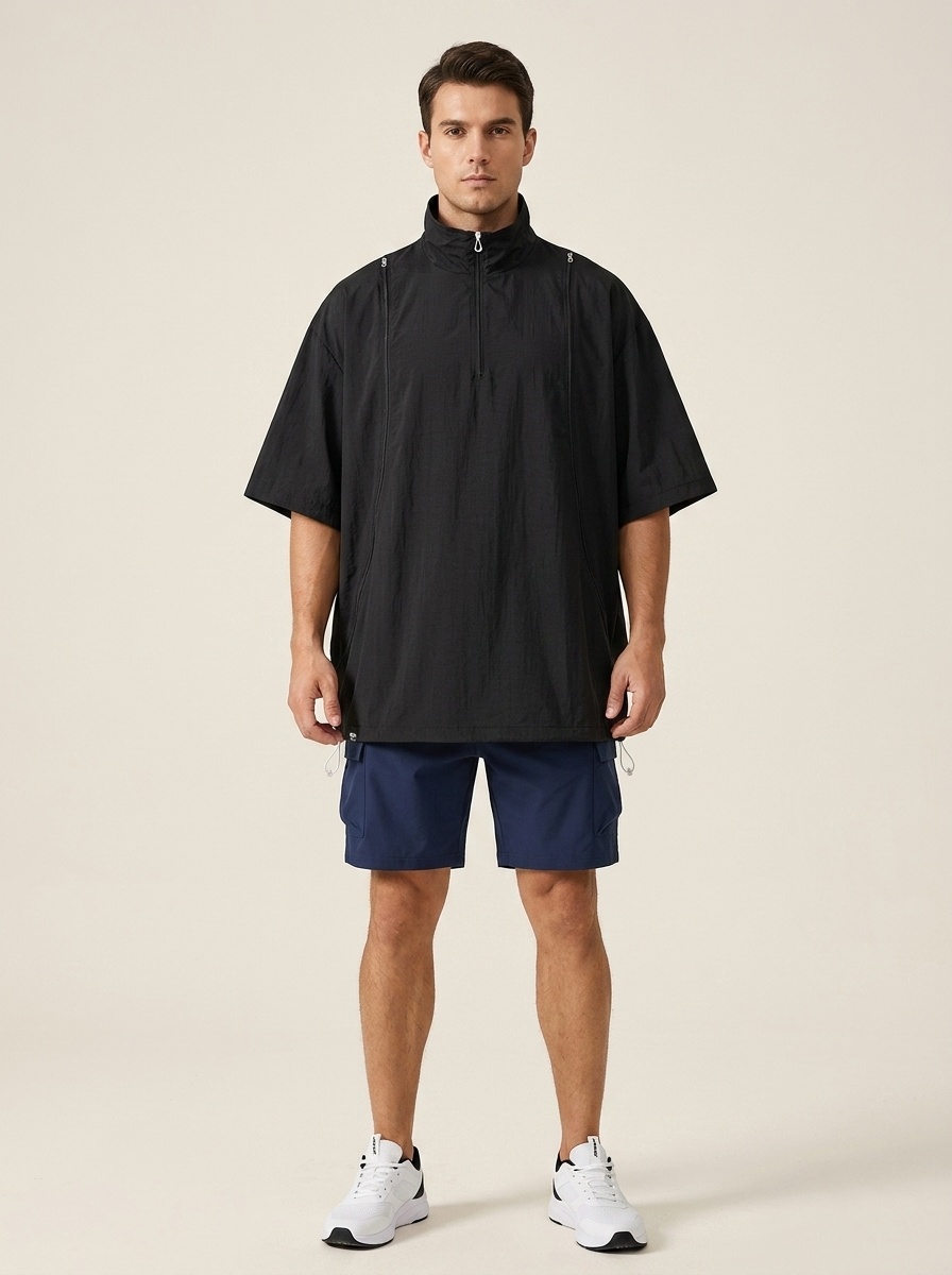 Poncho deportivo unisex ligero con media cremallera.