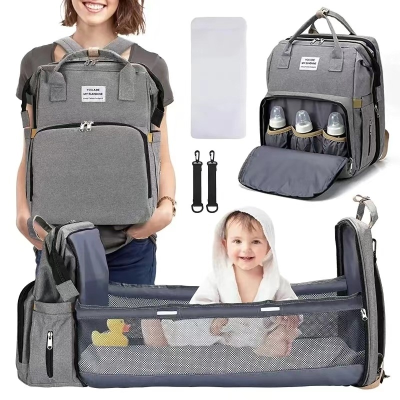 Mochila cambiador 2 en 1 con moisés portátil, cambiador, bolsillos térmicos y puerto de carga USB.