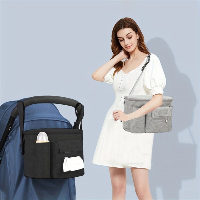Bolsa organizadora universal para cochecito con correa de hombro desmontable, portavasos térmicos y múltiples bolsillos para guardar los artículos esenciales del bebé.