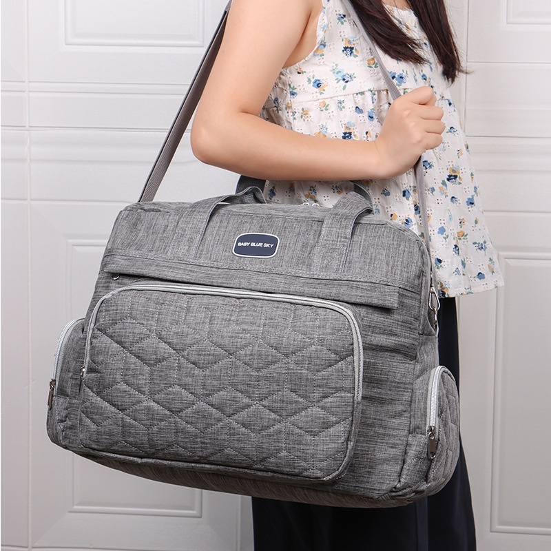 Bolso cambiador acolchado multicompartimento, bolso de viaje impermeable para bebé con cambiador acolchado y bolsillos de almacenamiento isotérmicos.